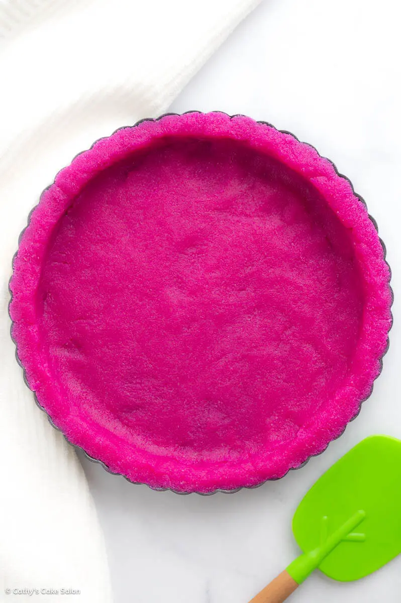 An unbaked dragon fruit pie crust made with gluten free almond flour and dragon fruit powder.