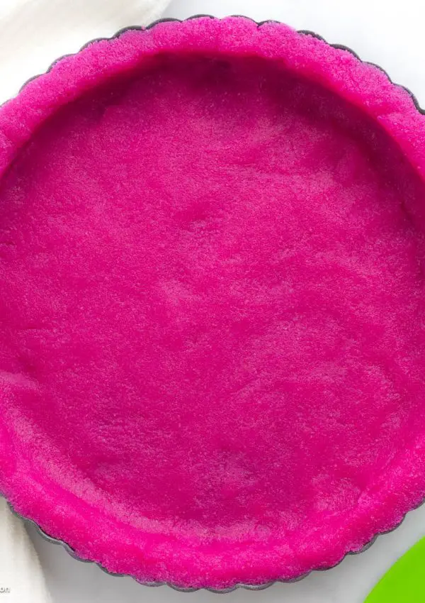 A dragon fruit pie crust made with gluten free almond flour and dragon fruit powder.