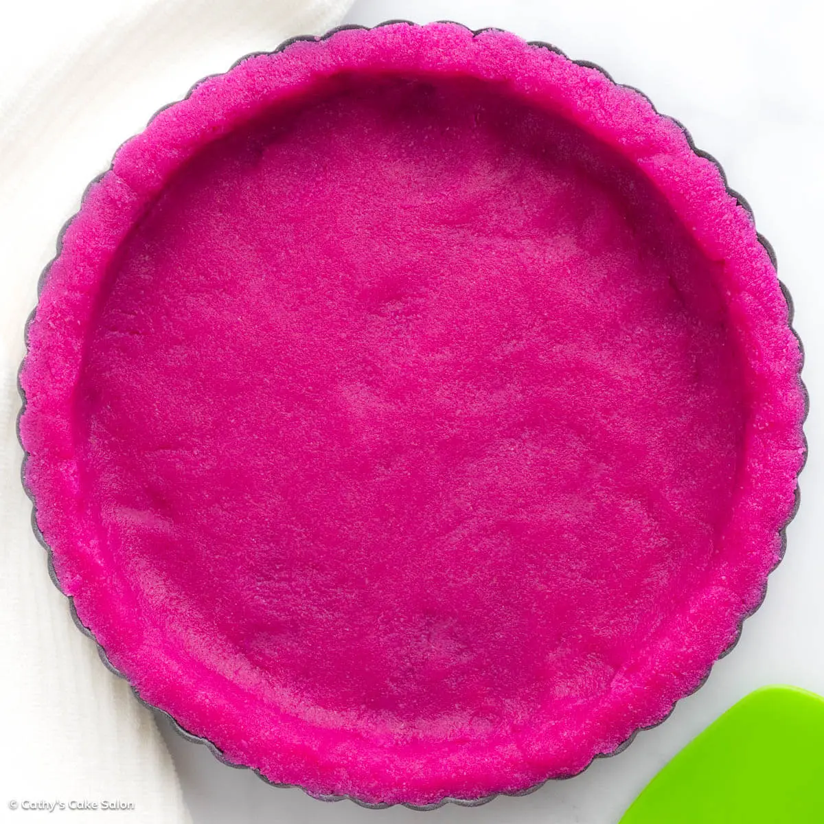 A dragon fruit pie crust made with gluten free almond flour and dragon fruit powder.