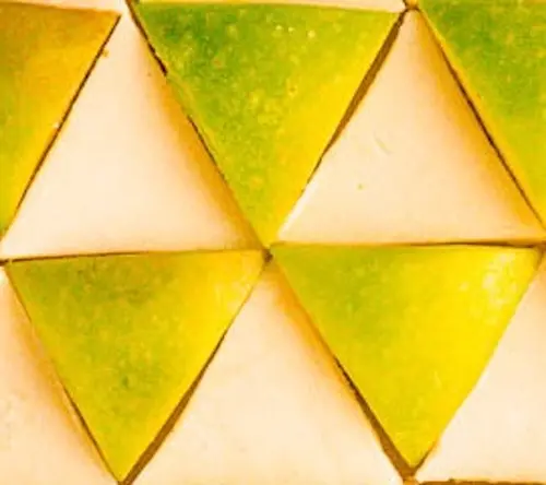 A step in the recipe: Positioning white chocolate and apple triangles so they form the shape of a radiation symbol.
