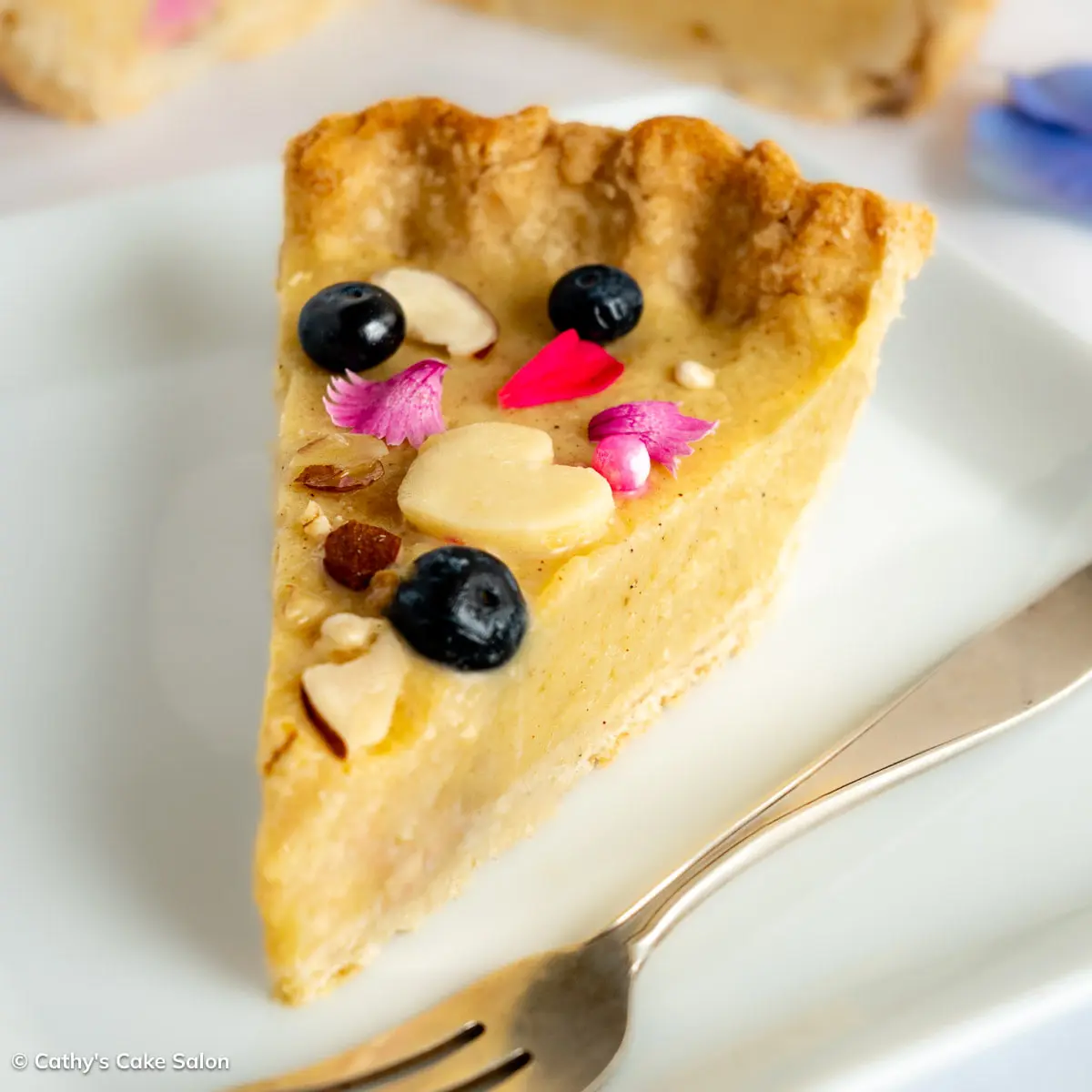 A slice of pear tart in a gluten free tart crust.
