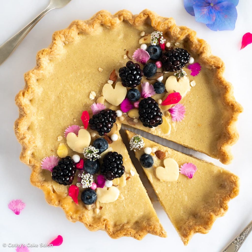 Gluten free pear tart in an all butter gluten free tart crust topped with blackberries, blueberries and sugar free white chocolate.