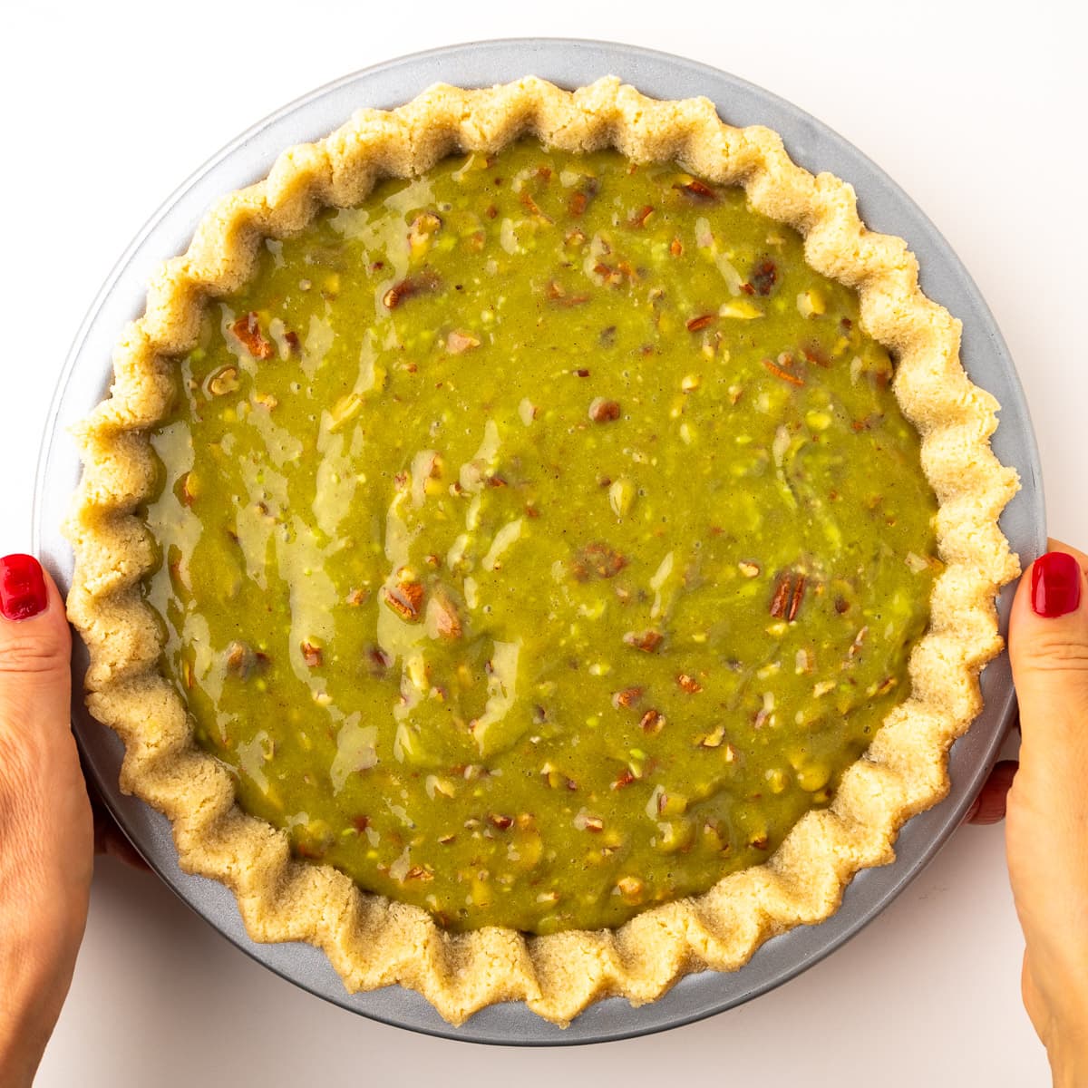 A step in the recipe: Pour the filling into the almond flour tart crust.