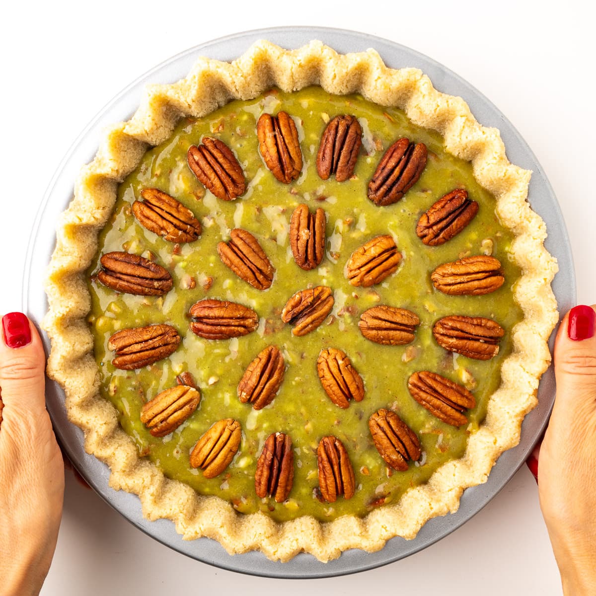 A step in the recipe: Top with pecans.