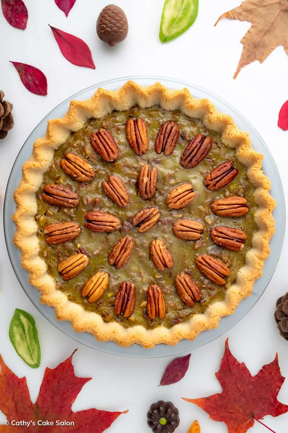Sugar free pecan pie in a low carb almond flour pie crust topped with pecans.