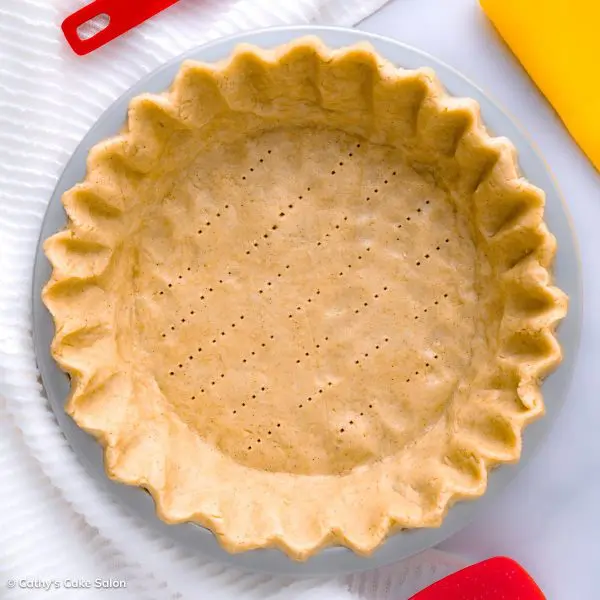 An unbaked vegan gluten free pie crust in a pan.