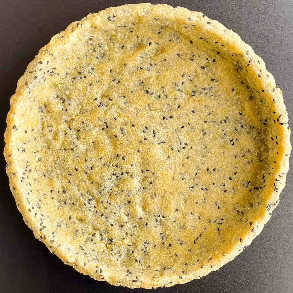 A step in the recipe: Make the almond flour tart crust recipe with black sesames and apple cider vinegar.