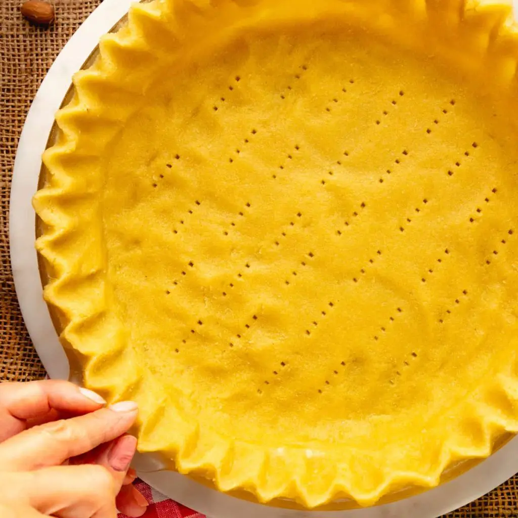 A step in the lemon meringue pie recipe: Fluting a pie crust.