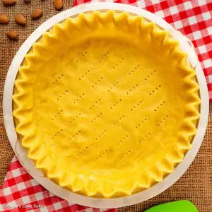 A monk fruit sweetened almond flour pie crust in a pie pan.