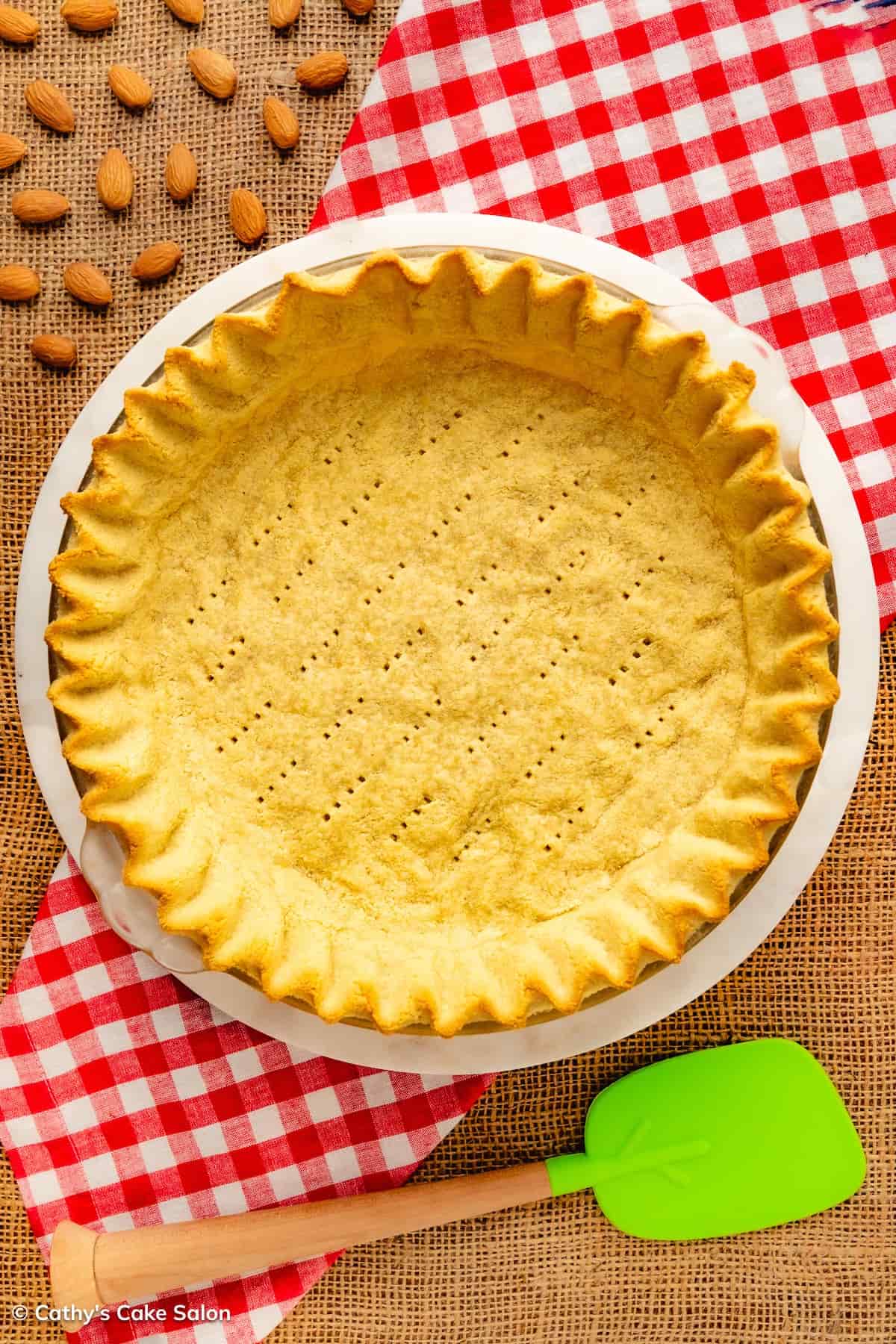 A baked sugar free, diabetic, gluten free, keto, almond flour pie crust in a pie pan.