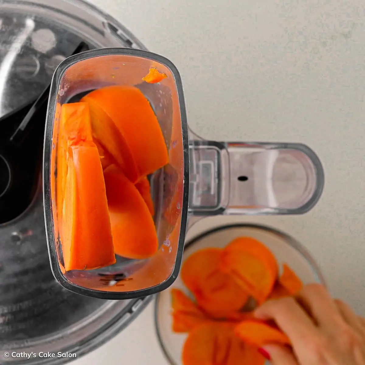 Step three in this recipe: Put the persimmon in the food chopper.
