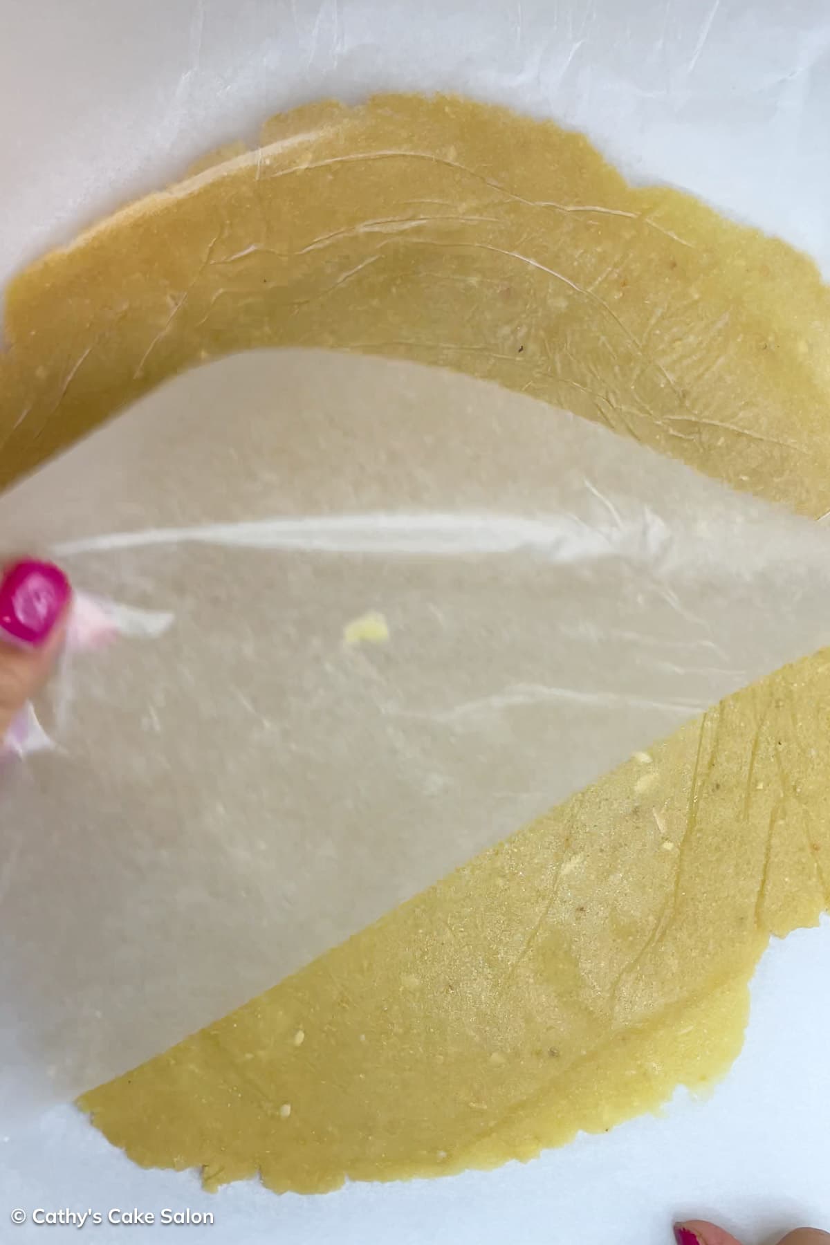 Step 4 to make this recipe: Remove the parchment paper from the almond flour pizza crust.