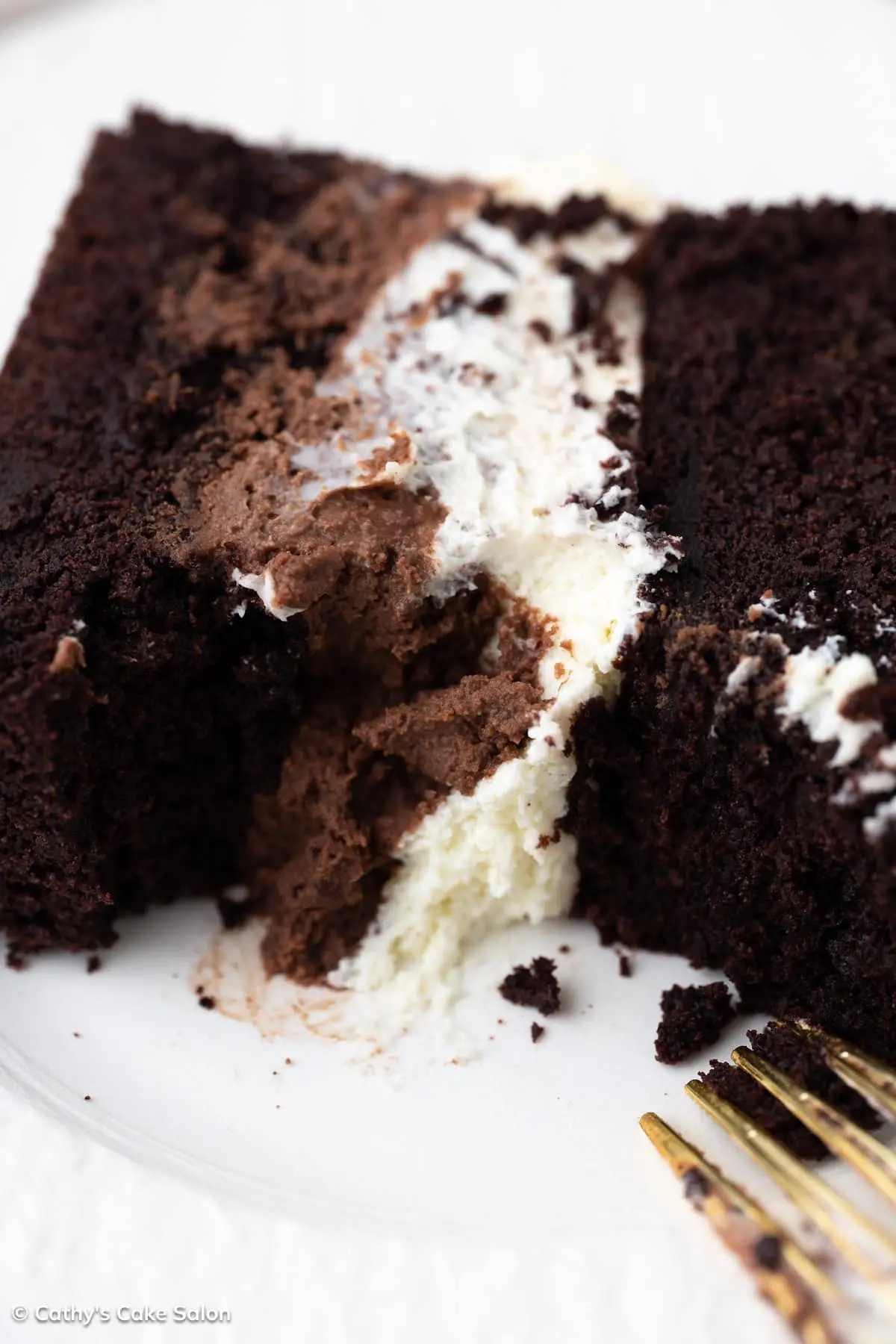 A slice of Costco tuxedo cake with chocolate mousse and white chocolate mousse.