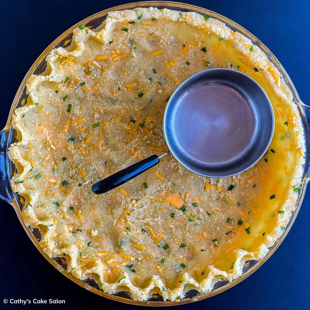 Step 3 in this recipe: Use a mini saucepan to flatten the bottom of this almond flour crust for quiche.