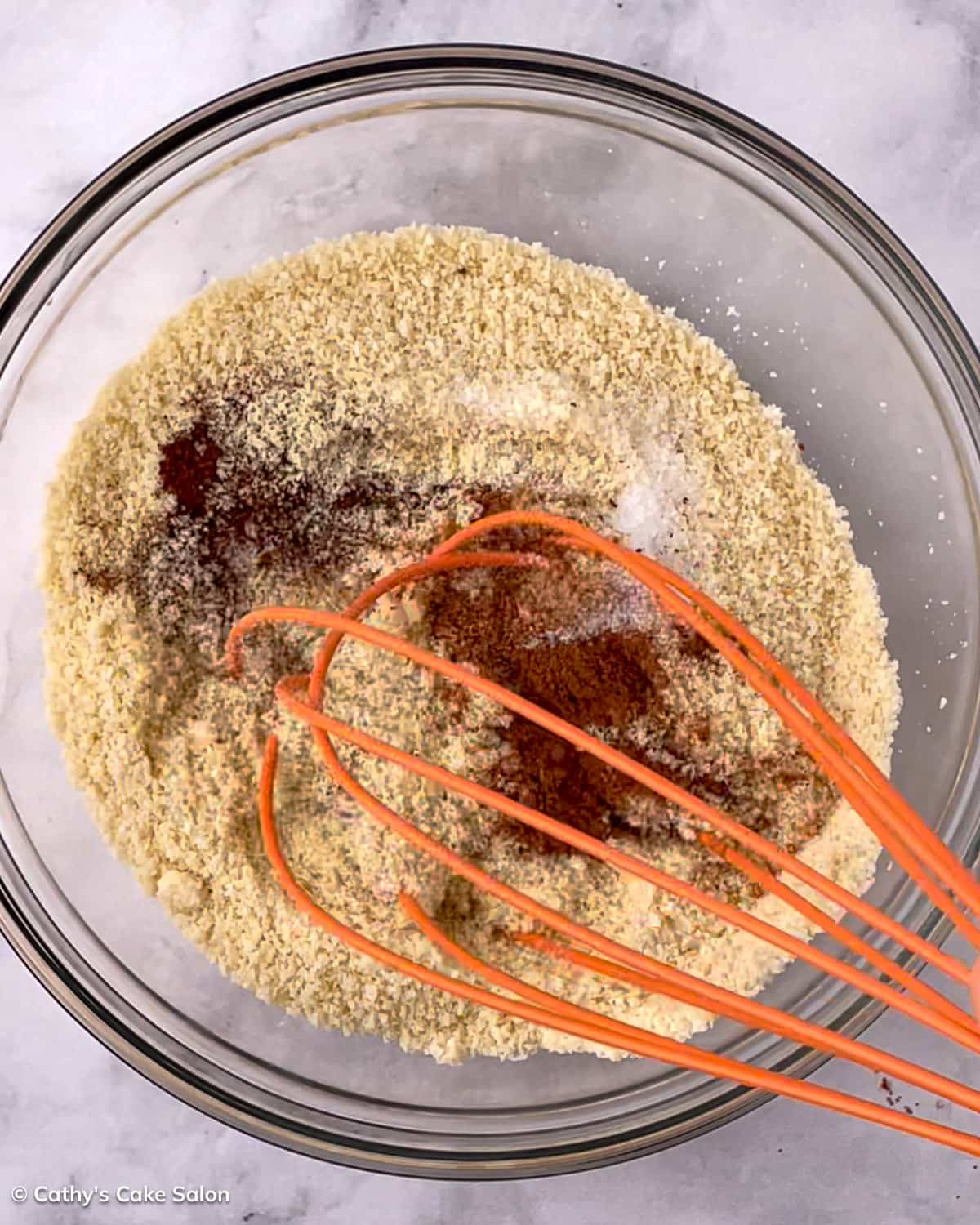 A step in the black cake recipe: Whisk the dry ingredients and holiday spices.