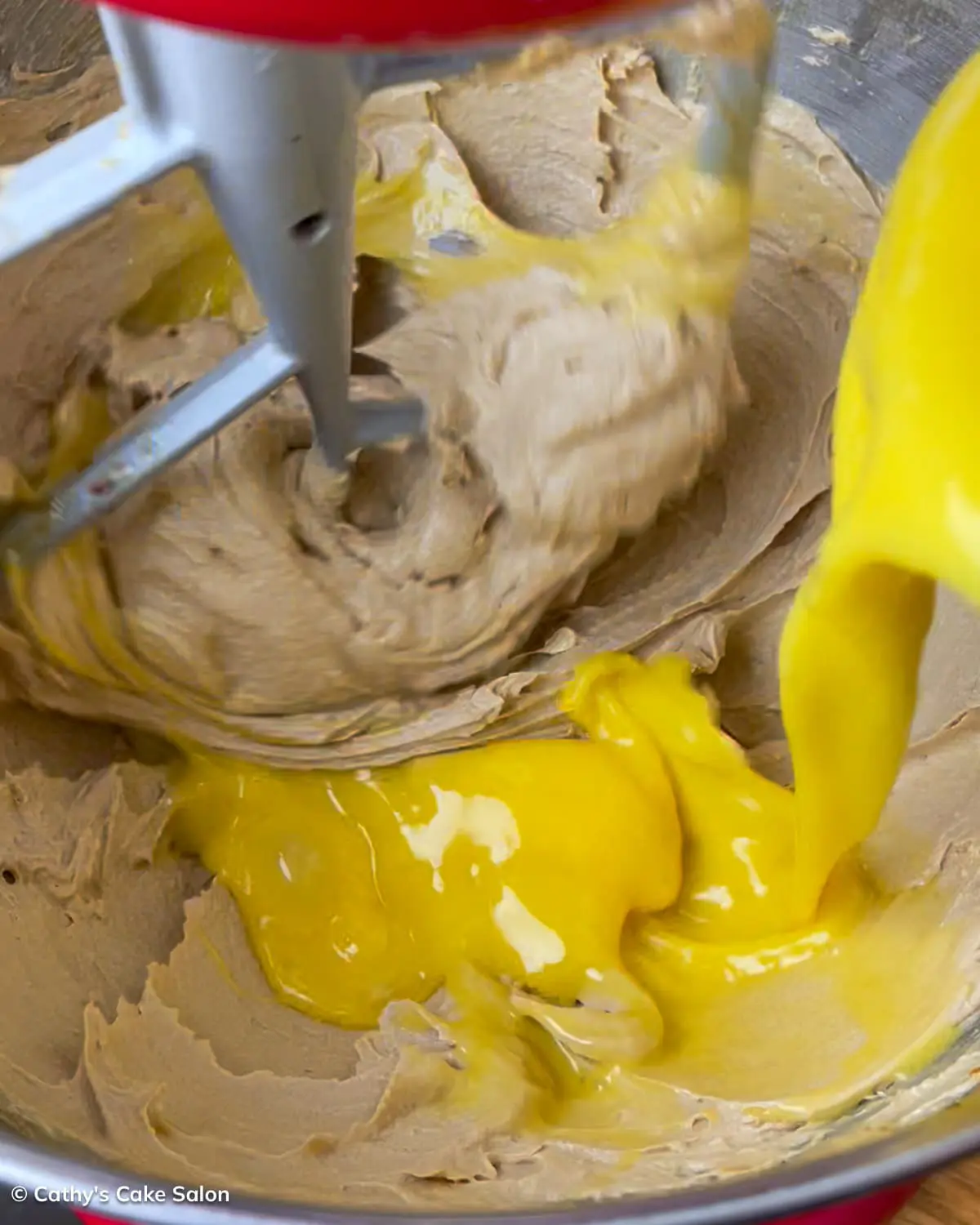 A step in the recipe: Add the beaten eggs to the butter and sugar.