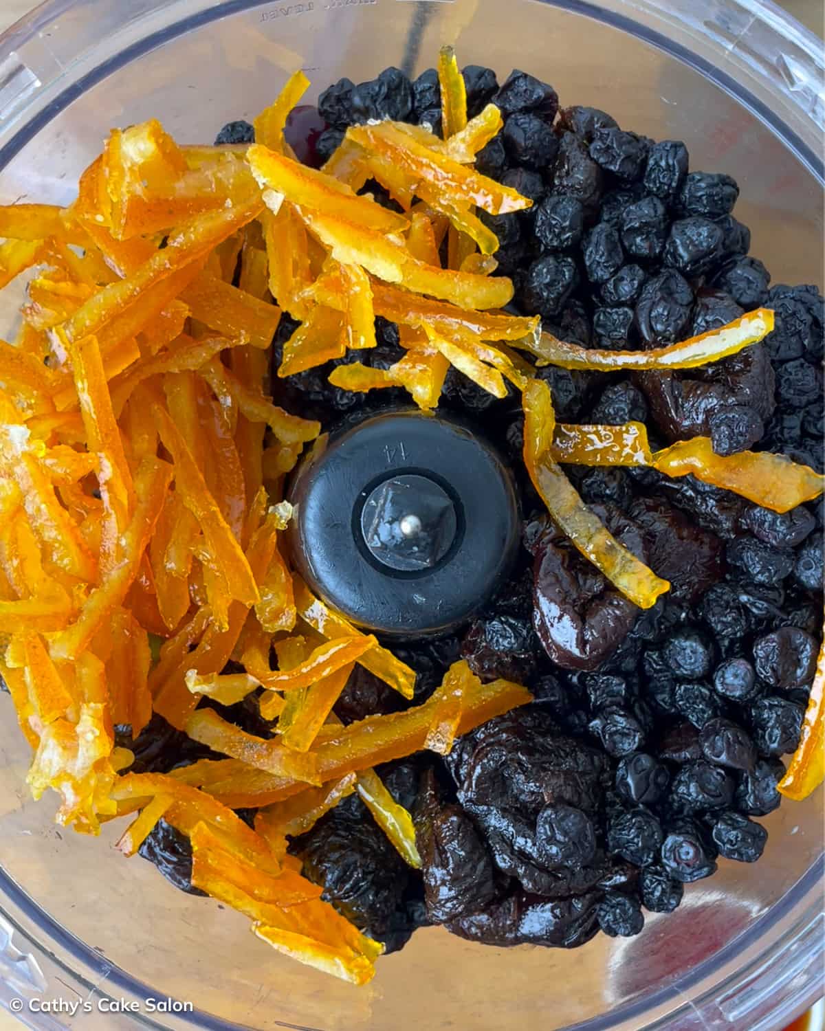 A step in the black cake recipe: puree the fruits with port wine and dark rum.