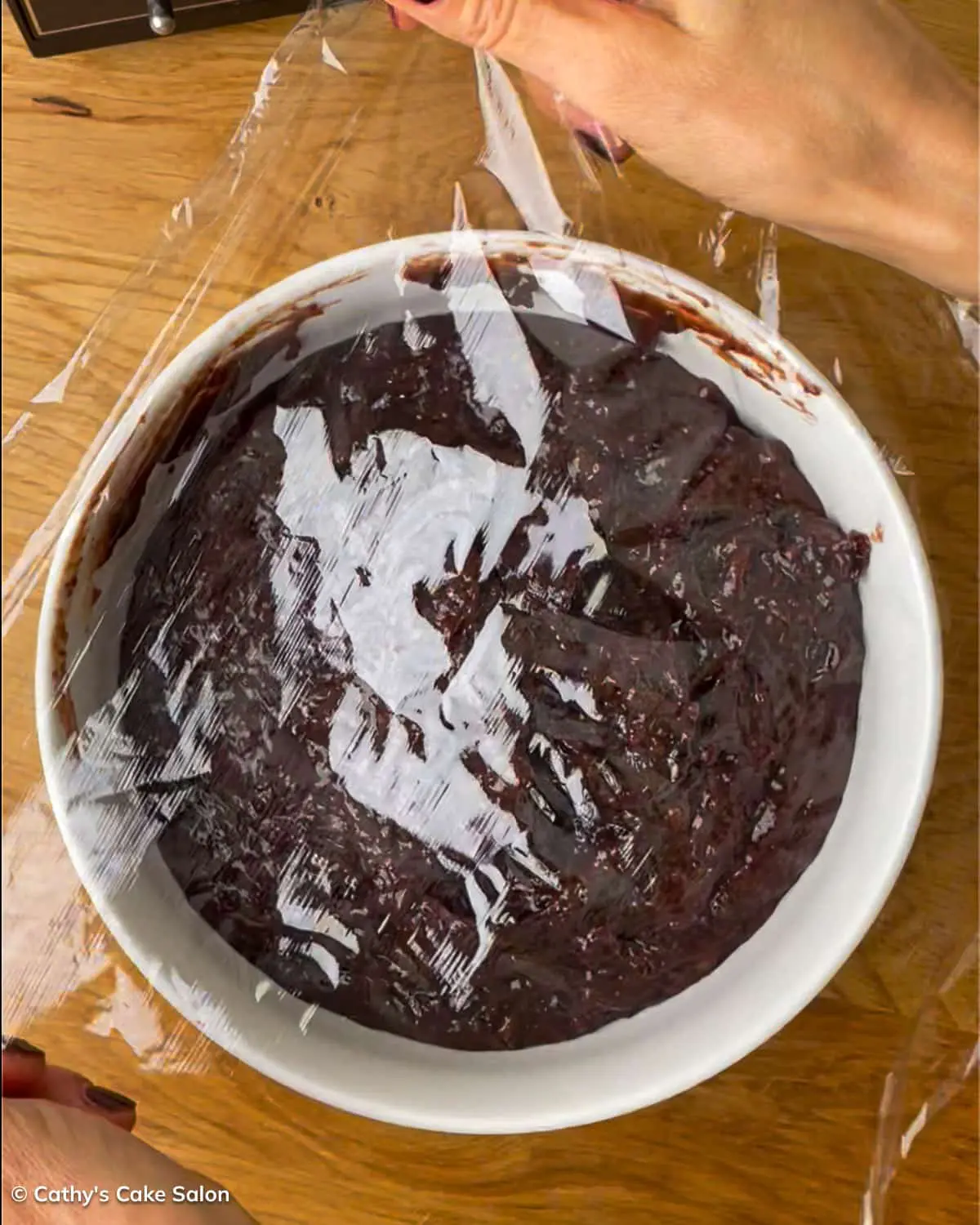 A step in the black cake recipe: Cover the pureed fruit and let it marinate.