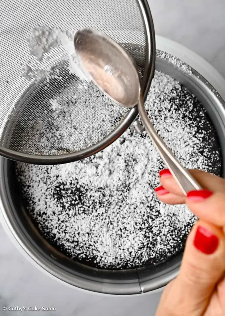 Step 9 to make the recipe: Sprinkled powdered or confectioner's sugar on top of the chocolate cake.