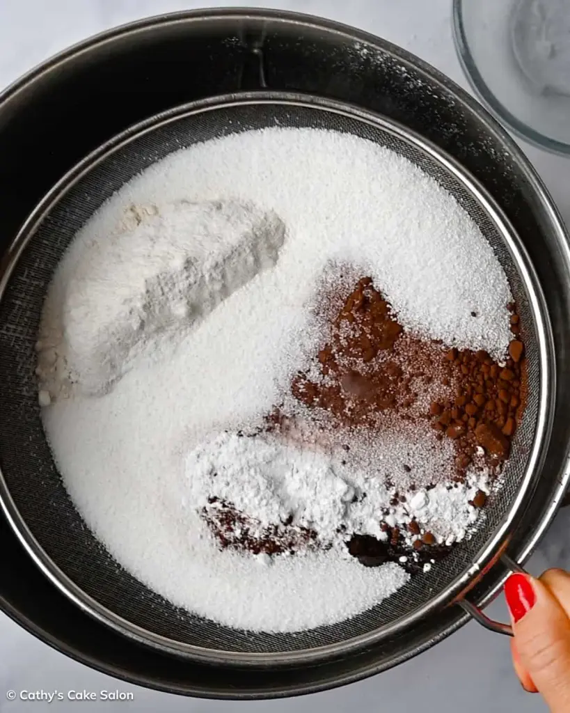 Step 1 to make the dark chocolate devil's food cake recipe: Sift the dry ingredients.
