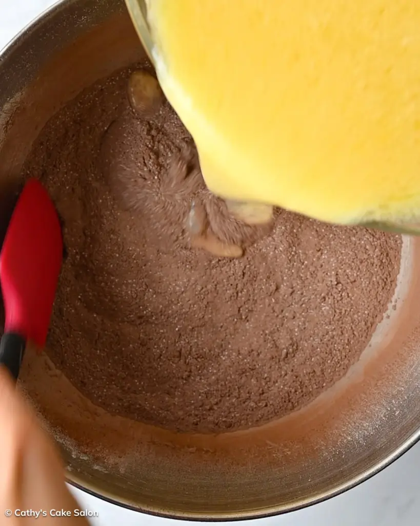 Step 3 to make the dark chocolate devil's food cake recipe: Add the wet ingredients to the dry ingredients.