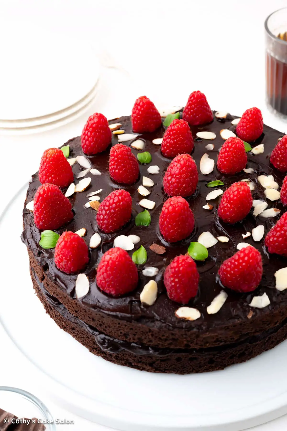 A keto chocolate raspberry cake topped with almond slivers.