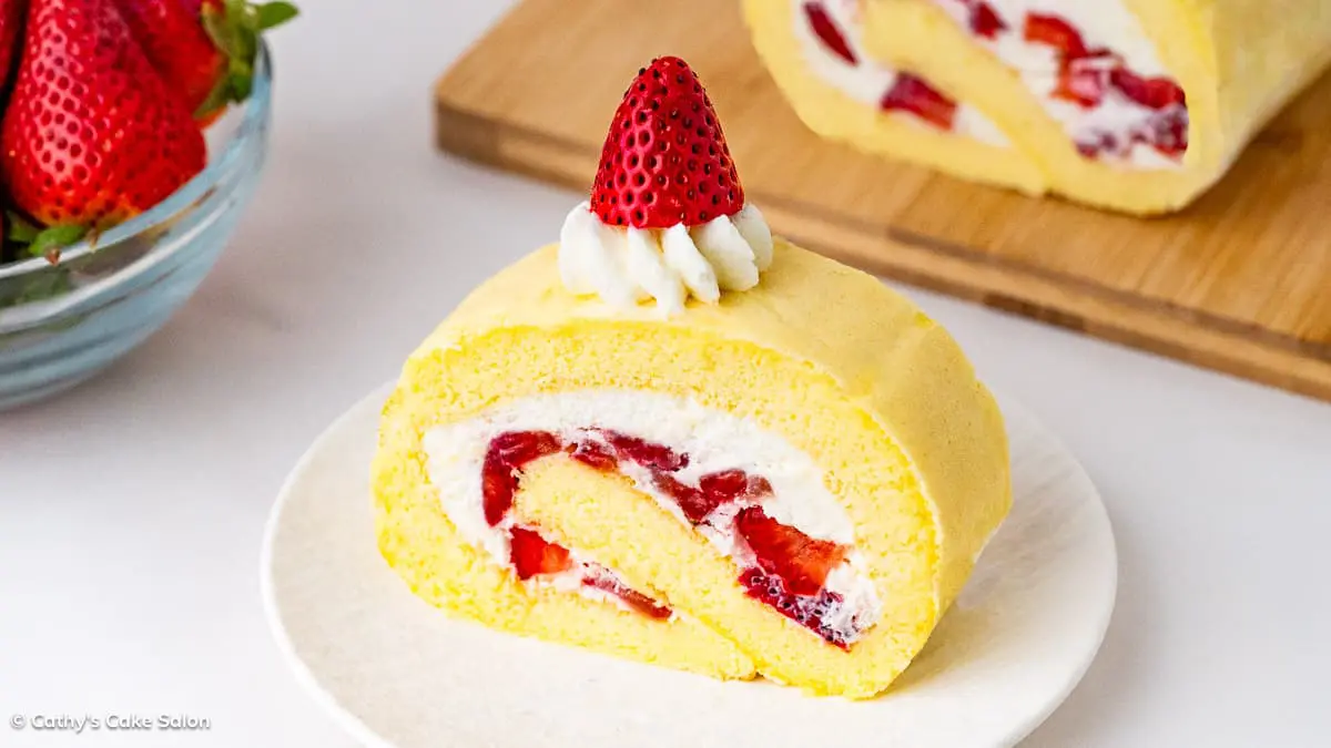 The result of this light and airy Japanese Strawberry Roll Cake Recipe: A slice of rolled Japanese strawberry cake.