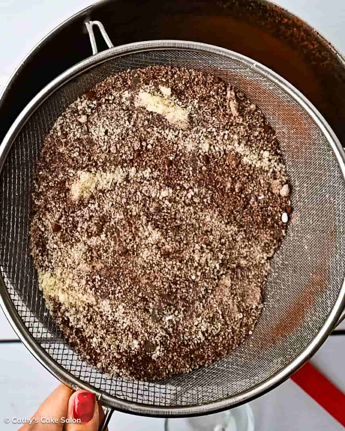 A step in the recipe: Sift the almond flour, coconut flour, monk fruit sweetener, Dutch Processed Cocoa Powder, natural cocoa powder, baking powder, espresso powder, and salt.