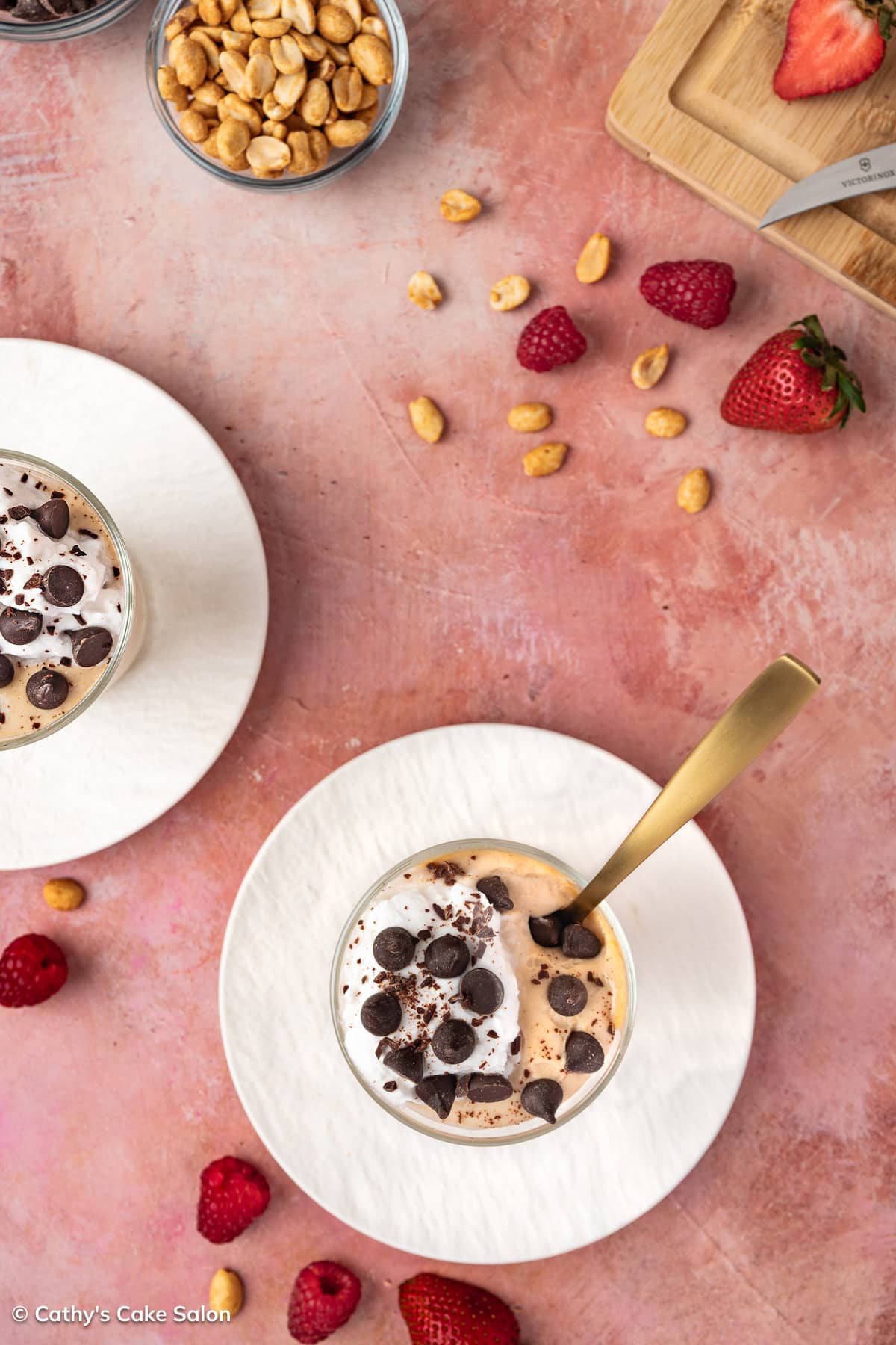 Cottage cheese chocolate peanut butter mousse in cups served with raspberries, strawberries, sugar free chocolate chips, peanuts and whipped cream.