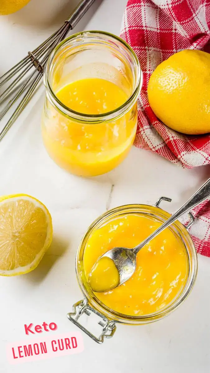 A spoon in a jar of low carb, keto lemon curd next to an open jar of diabetic lemon curd.