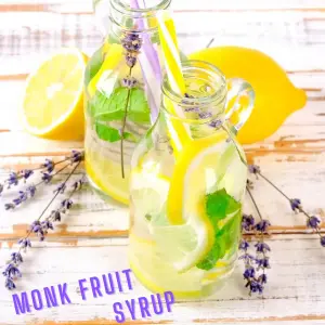 2 glasses of water sweetened with monk fruit syrup and filled with fresh lemon slices and lavender branches.