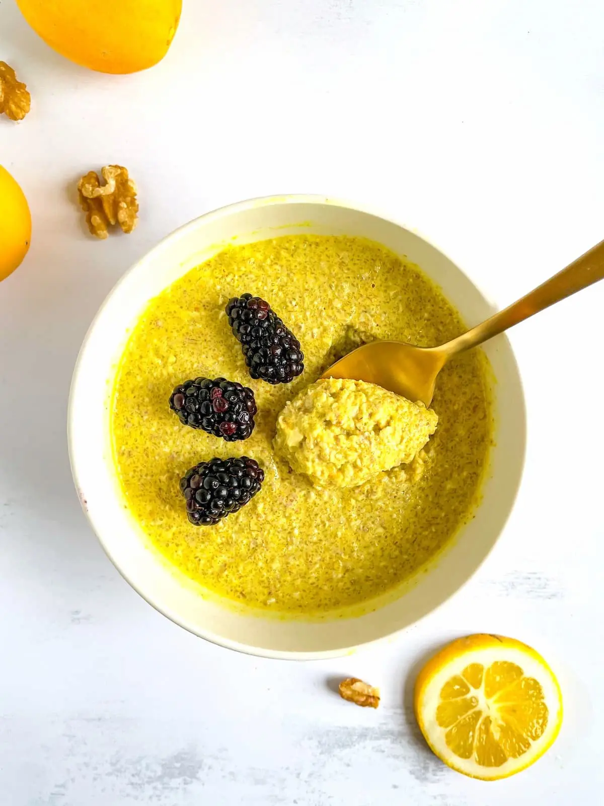 Glowing skin starts with a bowl of turmeric lemon overnight oats topped with fresh blackberries and sweetened with zero-calorie monk fruit sweetener.